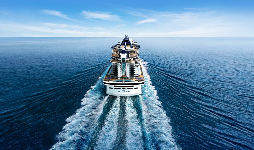 A modern cruise ship navigating through calm blue waters | MSC Cruises A modern cruise ship navigating through calm blue waters | MSC Cruises