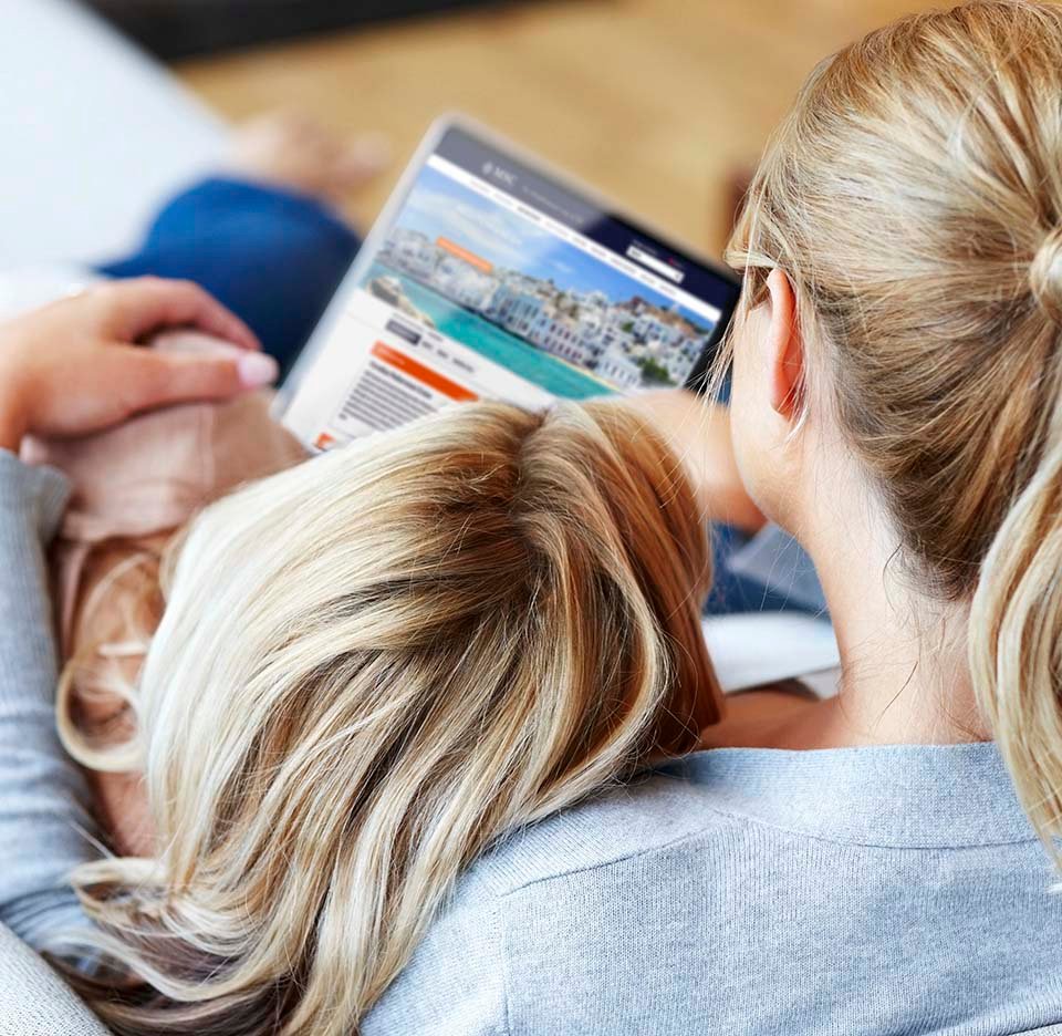 A woman and child browsing MSC Cruises destinations on a tablet | MSC Cruises