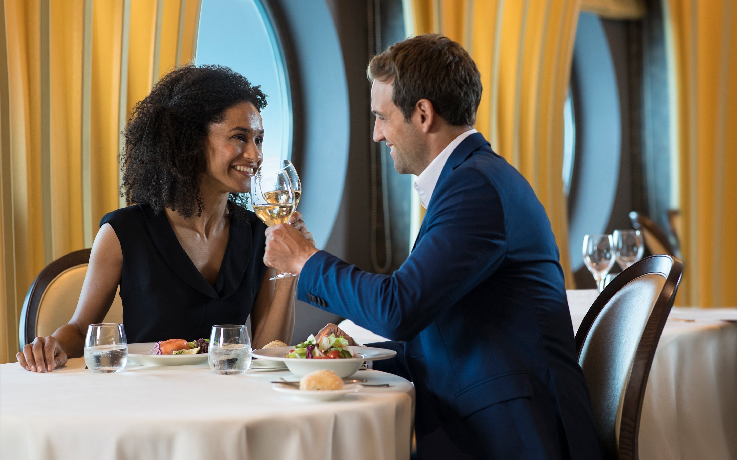 Couple dining with ocean views in an elegant cruise ship restaurant | MSC Cruises Couple dining with ocean views in an elegant cruise ship restaurant | MSC Cruises