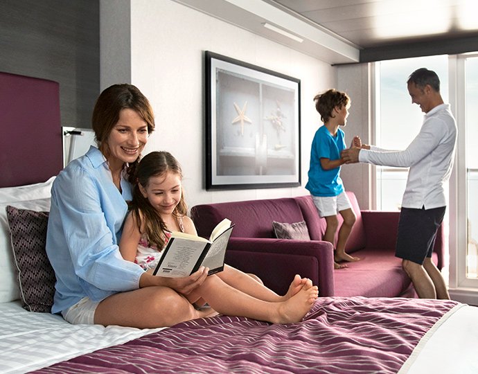 Family enjoying a modern cruise cabin with a balcony | MSC Cruises Family enjoying a modern cruise cabin with a balcony | MSC Cruises