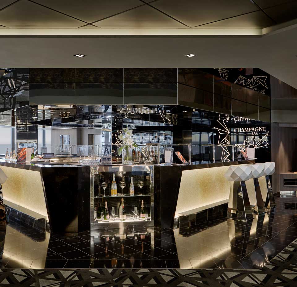 Elegant champagne bar with modern decor and illuminated counters on an MSC cruise ship | MSC Cruises Elegant champagne bar with modern decor and illuminated counters on an MSC cruise ship | MSC Cruises