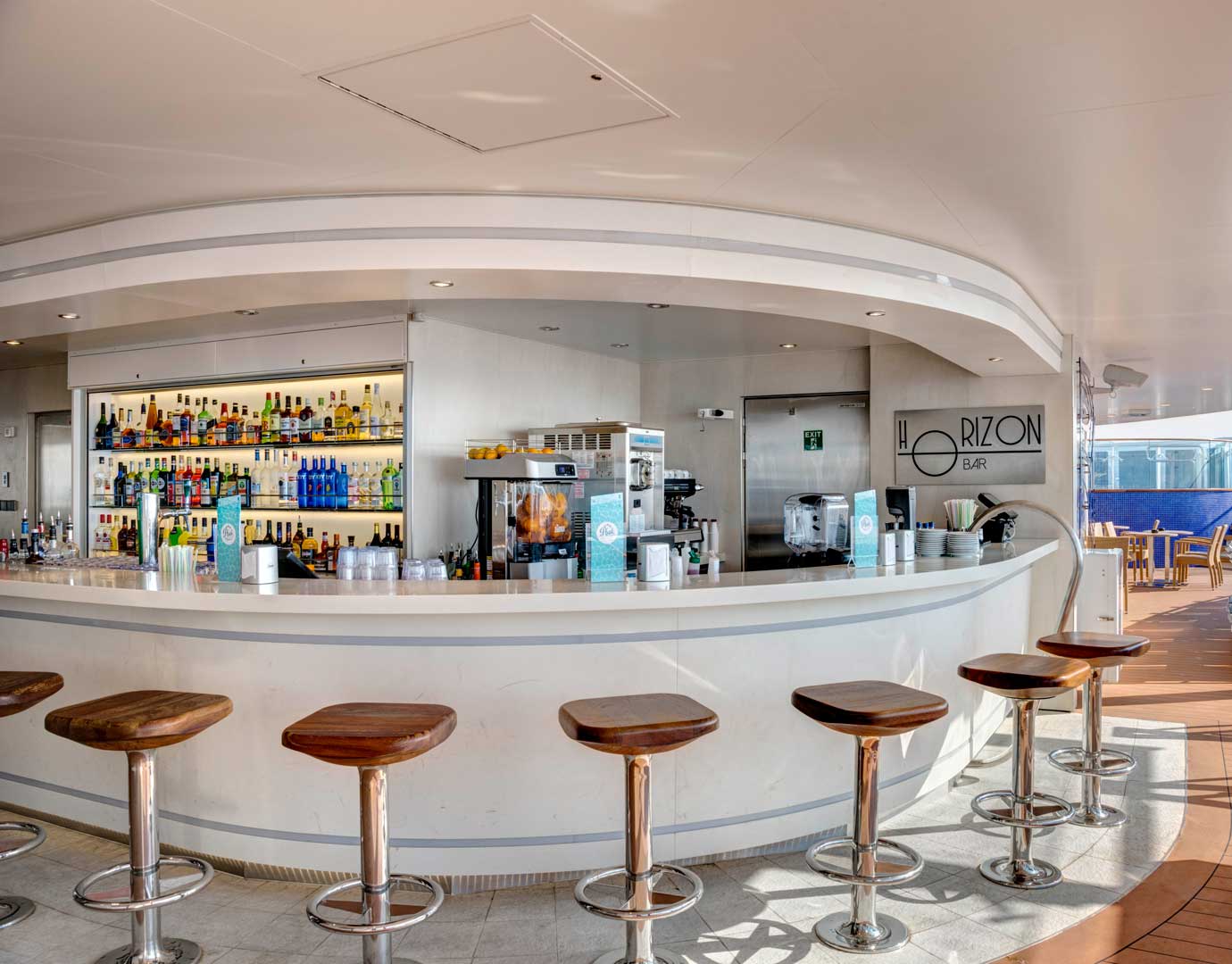 Horizon Bar on an MSC cruise ship with a sleek counter, wooden stools, and a wide selection of beverages | MSC Cruises Horizon Bar on an MSC cruise ship with a sleek counter, wooden stools, and a wide selection of beverages | MSC Cruises
